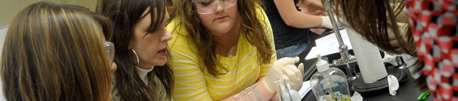 Tamara Popplewell demonstates an experiment to students in lab.