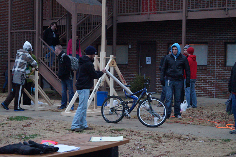 A group of students tests out a water balloon launcher in EGR 101