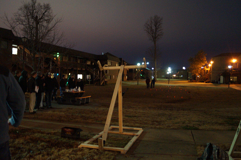 A group of students tests out a water balloon launcher in EGR 101