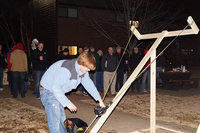 A group of students tests out a water balloon launcher in EGR 101