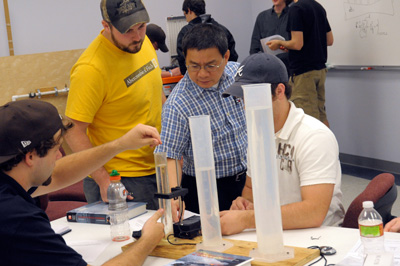 Dr. Van helping students in lab