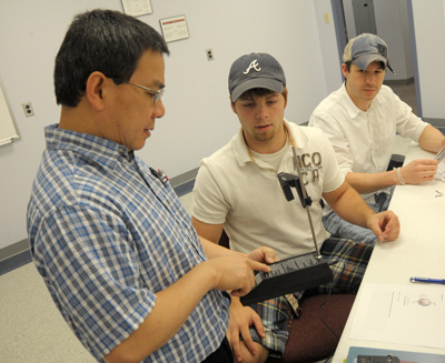 Dr. Van helps a student in lab
