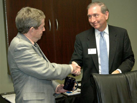 Dean Tom Rosebrough (right) presents an official Ed.D mug to Benny Bills, director of schools in Sumner Coutny, for his support of Union and the expansion of the Ed.D. to Hendersonville.