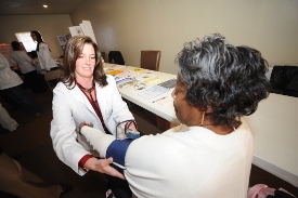 Union nursing student Jennifer Mazur checks Donnie Jackson's blood pressure at Parkview Apartments Jan. 19. (Photo by Morris Abernathy)