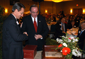 Claude Pressnell, president of the Tennessee Independent Colleges and Universities Association and former Union trustee, presents Union University President David Dockery with a 1620 copy of Augustine's 