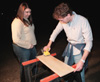 Assignment: Trading Spaces - Junior Jennifer Allen, art major, and junior Tyler Flatt, digital media studies major, work on sanding down the cabinet doors outside Hurt Commons. - Photo by Kristen Hiller