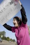 Freshman nursing major Megan Daniel enthusiastically advertises the Zeta Tau Alpha Breast Cancer Awareness Walk-A-Thon on Saturday, Oct. 25. - Photo by Beth Spain