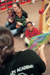 3/24/03 - Lezli-O'Neal Sullivan holds two of the children in day care at the Salvation Army's Perdue Center of Hope while Julie Propst reads them a story during GO Memphis.