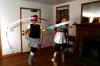 Rose Rogers and Lily Zophi, both senior art majors, twirl the ribbons that are part of their costumes for the art retreat costume party. - Photo by Kristi McMurry