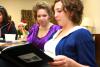 Kelsey Roberts, junior art major, and Ellen Kay, senior art major, look through Kelsey's sketchbook at the annual art retreat. - Photo by Kristi McMurry