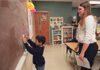Crane looks on as one of her students fills blanks with correct words on the chalkboard. Crane is the only TESL major student teaching this semester. The TESL major can be fulfilled as a bachelor of arts degree or be joined with the Education Department in order to obtain teaching licensure. - Photo by Kristen Hiller