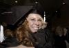 Amy Anderson, English graduate, shares her excitement with a fellow graduate after fall graduation. - Photo by Beth Spain