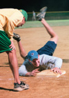 Sophomore Gary Snuffin, Christian ministry and recreation major, slides onto the plate where junior Matt Nason, sports management major, calls the play. Lambda Chi Alpha 2 defeated Onions 1 on Monday, April 21 by a score of 6-5 at the West Jackson Baptist Church softball field. - Photo by Justin Veneman