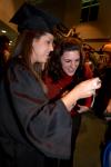 12/19/08 - Rindi Tennyson, accounting graduate, looks at her camera with her friend, Laura Byrd, after the fall graduation ceremony. - Angela Abbamonte
