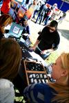 Rose Rogers, senior art major, takes orders for her handmade rings and other jewelry at Arts in the Park. - Photo by Kristi McMurry