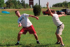 Assignment: Ultimate Frisbee Intramurals - Resident Director Bobby Ludwig makes a pass as 2002 alumnus Matt Thomas plays defensively. - Photo by Kristen Hiller