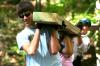 Chad Keathley, junior theology major, helps to carry a cedar plank for placement in the construction of a simple bog bridge at Pinson Mounds. - Photo by Kristi McMurry
