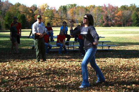 Caitlin Roach, freshman history major, tries out atlatl spear-throwing during an afternoon learning session during Day of Remembrance.  