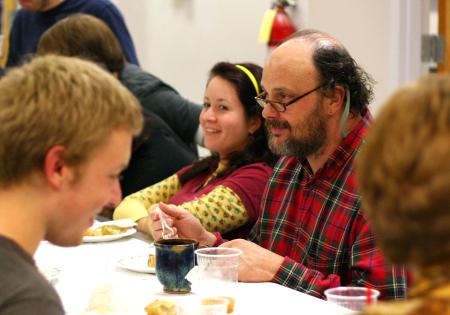 Lee Benson, art department chair, and Kelsey Nagy, sophomore art major, fellowship with other members of the art department and the annual Thanksgiving dinner.