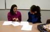 Blair Hoglen, senior intercultural studies major, and Sarah Logan, senior business administration major, critique each other's papers for the Language capstone group. - Photo by Kristi McMurry
