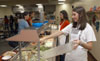  Freshman Stacie Scholl (right) and  Sophomore Anna White  (center) serve food to their fellow Unionites in the cafeteria.  They were among several students who volunteered to fill in for workers whose homes were damaged by the tornado.
 - Photo by Jim Veneman