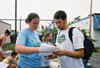 Students Meredith Williams and Troy Wallach prepare to deliver bottled water and food to tornado victims in East Jackson. - Photo by Justin Veneman