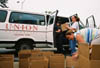 Stacie Herr, wife of Residence Director Dan Herr, packs up boxes of food for distribution to tornado victims in East Jackson. - Photo by Justin Veneman