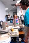 Professional potter Mark Shapiro, used a blow torch to stiffen the clay he is working with while Lori Landon, sophomore art major, looks on.  Shapiro gave a two day long ceramics workshop. - Photo by Kristi McMurry