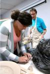 Rose Rogers, senior art major, helps roll some coils for Mark Shapiro to use in his demonstration.  Shapiro gave a two-day ceramics workshop for students and faculty. - Photo by Kristi McMurry