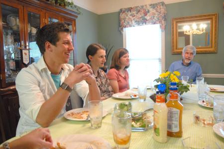 J. Landham, freshman, Hannah Williams, sophomore athletic training major, and Rebecca Eaton, sophomore mathematics major, laugh over a home-cooked meal at the home of Bill and Alice Nettles as part of Be Our Guest.