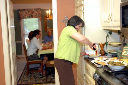 Alice Nettles, wife of Dr. Bill Nettles, prepares dessert for her guests.  Union students dined at the Nettles' home as a part of Be Our Guest.