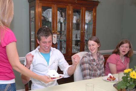 Emily Chambers, freshman youth ministry major, serves J.Landham, freshman, his strawberry shortcake overflowing with whipped cream at the home of Bill and Alice Nettles.  The Nettles served six Union students a home-cooked meal as part of Be Our Guest.