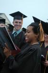 Nursing graduate Amber-Rose Hawkins and Kyle Odom sing the Alma Mater at the end of the spring graduation ceremony. - Photo by Beth Spain