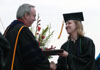 President David S. Dockery presents Social Work major Emily Price with her diploma at Spring Graduation 2003. - Photo by Jim Veneman