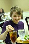 Tiffany Fredericks, senior marketing major, squeezes lemon into her tea at the 2009 Etiquette Luncheon.This annual event, hosted by First Lady Lanese Dockery and Sherry Tignor, teaches students proper interview etiquette. - Photo by Kristi McMurry