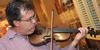 Gavin Richardson, associate professor of English, plays the violin along with a faculty band before the Faculty/Staff Dinner. - Photo by Morris Abernathy