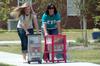 Elissa Weber, sophomore, and Heather Dragg, sophomore, help returning students move into their rooms in The Quads. - Photo by Beth Spain