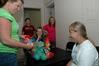 Rebecca Green, sophomore math major, receives a toy bear and nurse kit from her roommates mother Michelle Fry during returning student move-in day. - Photo by Beth Spain