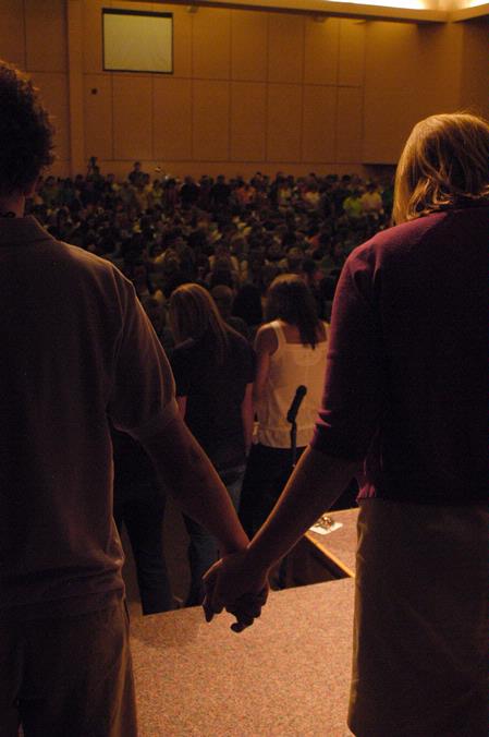 Dean of Students Kimberly Thornbury (right) joins hands with Josh Allen, senior Christian studies major, and other professors, parents, and upperclassmen as President Dockery prays for the new students at the close of the new student worship service during orientation.