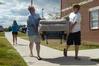 Ray, father of Taylor Burks, sophomore accounting major, and son Matt help move furniture into Taylor's room in the Quads. - Photo by Sarah Palmer