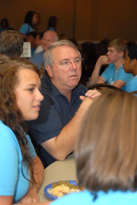 Michael Chute, professor of communication arts, talks with incoming freshmen who are interested in the communication arts department during new student orientation.
