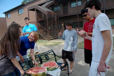 Students in the Heritage complex enjoy watermelon on a warm Sunday afternoon.
