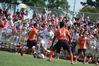 Guilherme Reis, freshman, dribbles the ball away from his Brewton Parker opponents. Watching him is a full crowd of fans enjoying Union's new soccer field stands. - Photo by Kristi McMurry