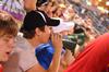 Nathan Fisher, junior English major, yells for the Diamond Jaxx during college night at Pringles Park. Faculty and students from Jackson schools were treated to a $1 game and discounted drinks and food. - Photo by Kristi McMurry