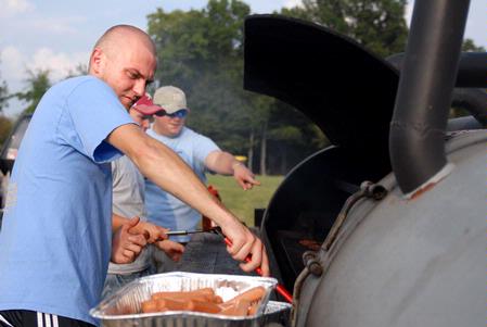 John Winfree, junior Christian Studies major, helps cook a meal for the Intrafraternity council (IFC) cookout.  This is one of the many events during RUSH. 