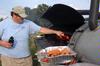 Russ Duck, sophomore biology major, helps cook a meal for the IFC cookout.  This is one of the many events during Rush.  - Photo by Kristi McMurry