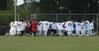 The soccer team kneels in prayer for Kevin Bradley, Senior, who was injured on the field during the men's soccer game against Reinhardt College on Sept. 12 - Photo by Sarah Palmer