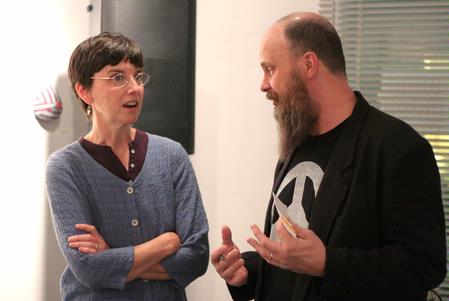 Linda Weatherly discusses the artwork in her exhibit "Exposure" with Lee Benson, art department chair.