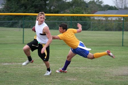 Lucas Nuefeld, senior nursing major, cuts across the field to avoid Wesley Klipfel, sophomore athletic training major, during a flag football game between SAE and the Clowns.