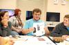 Rob Simpson, sophomore DMS major, shows his fellow AIGA members a design for a t-shirt. AIGA (American Institute of Graphic Arts) is an organization where students can network with the graphic design community through the Union chapter. - Photo by Kristi McMurry
